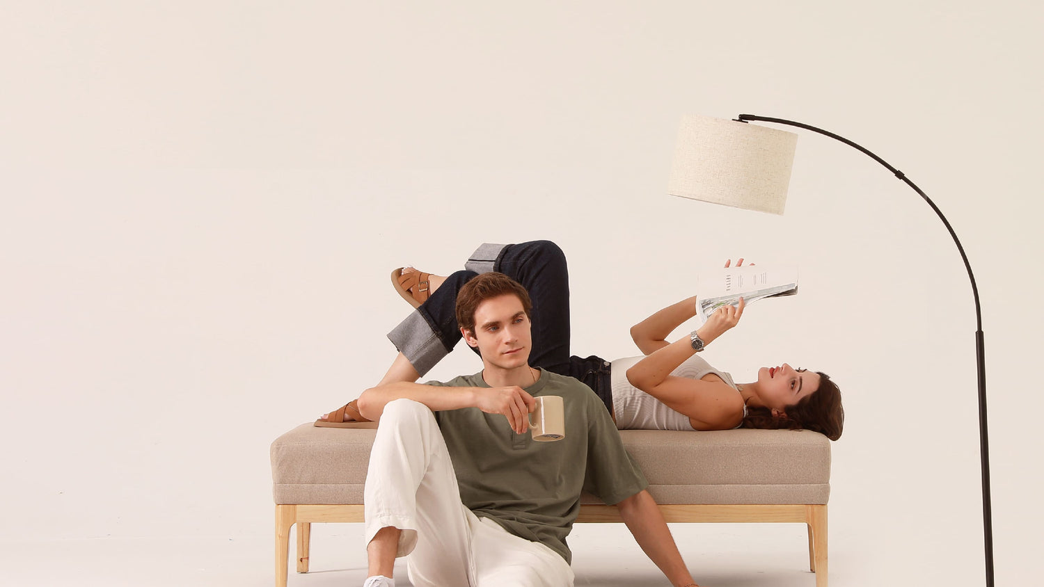 An arc floor lamp providing focused task lighting for a person reading a book in a cozy reading corner to prevent eye strain.