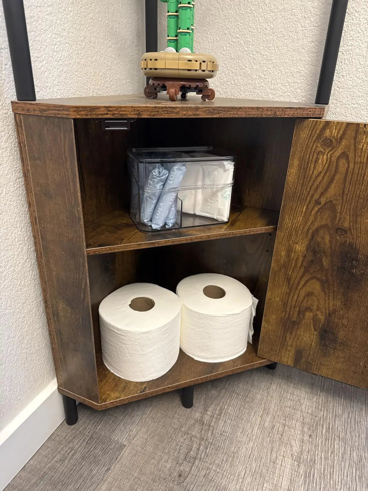 A compact corner cabinet shelf with a tiered design, perfect for small spaces like an entryway or bathroom, offering convenient storage for everyday essentials.