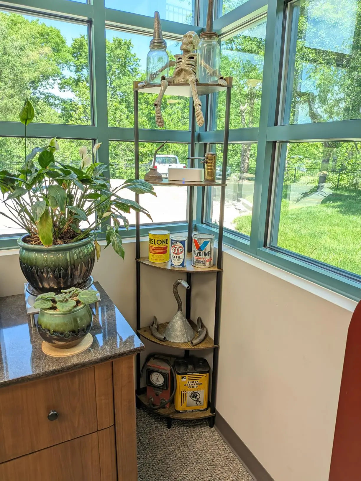 A compact, tiered corner shelf stand, perfect for optimizing storage in small spaces like a bathroom or entryway, holding essentials and decorative accents.