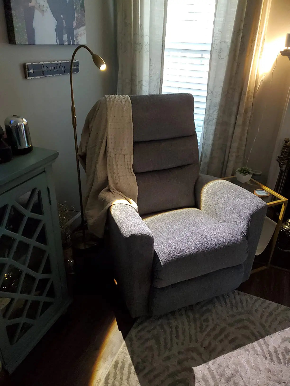 An adjustable LED spotlight floor lamp with a compact head, providing a strong, directed light beam, excellent for focused reading or task lighting in a contemporary living room.