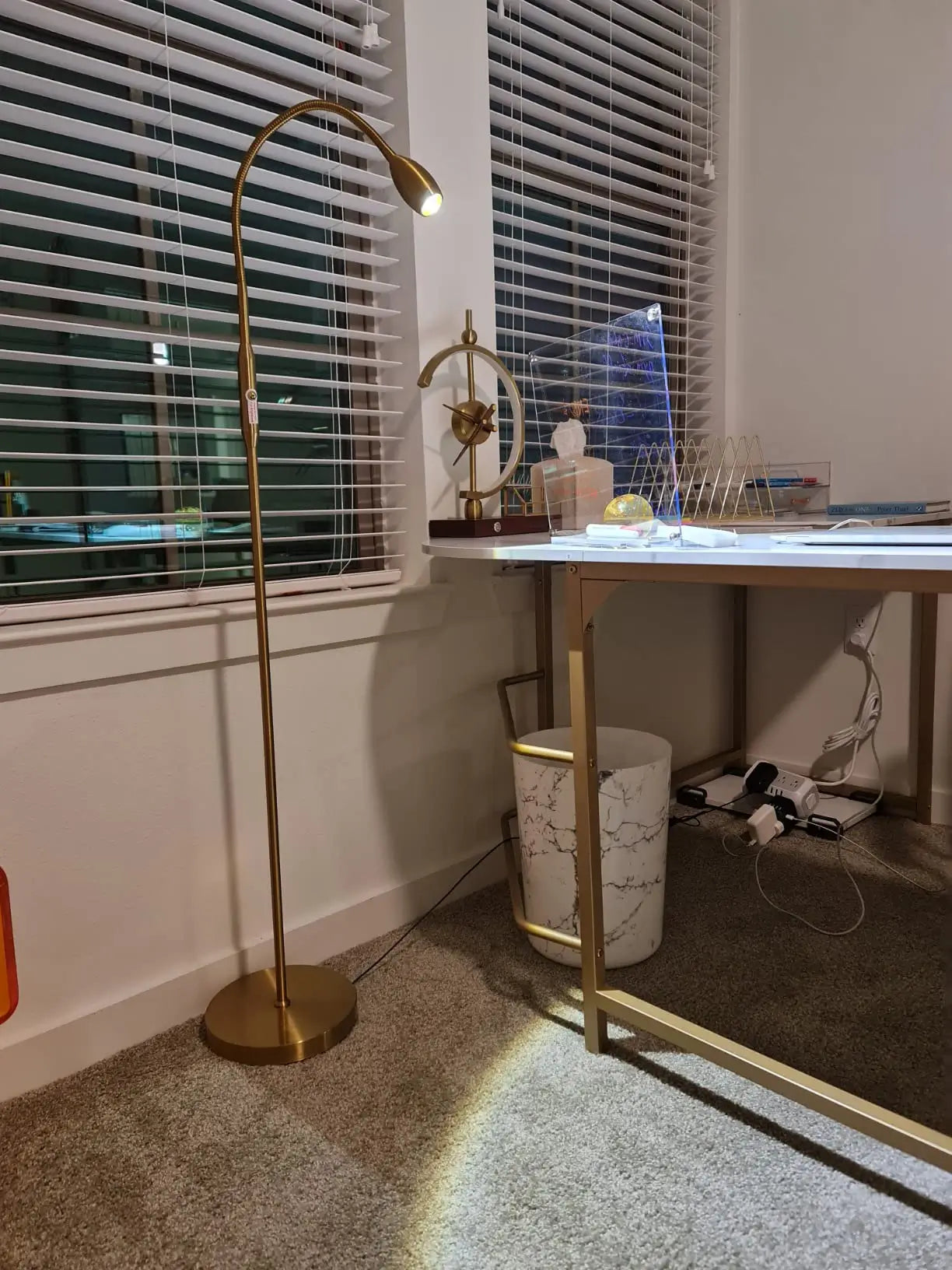 A contemporary white LED floor lamp with a distinct cylindrical head, designed to emit a precise beam of light, suitable for highlighting specific areas or objects in a modern interior.