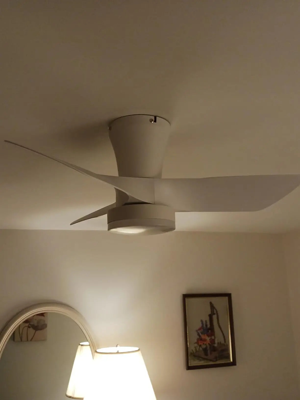 A decorative ceiling fan with a distinctive light fixture, combining functional air circulation with an eye-catching design element, enhancing the overall room aesthetic.