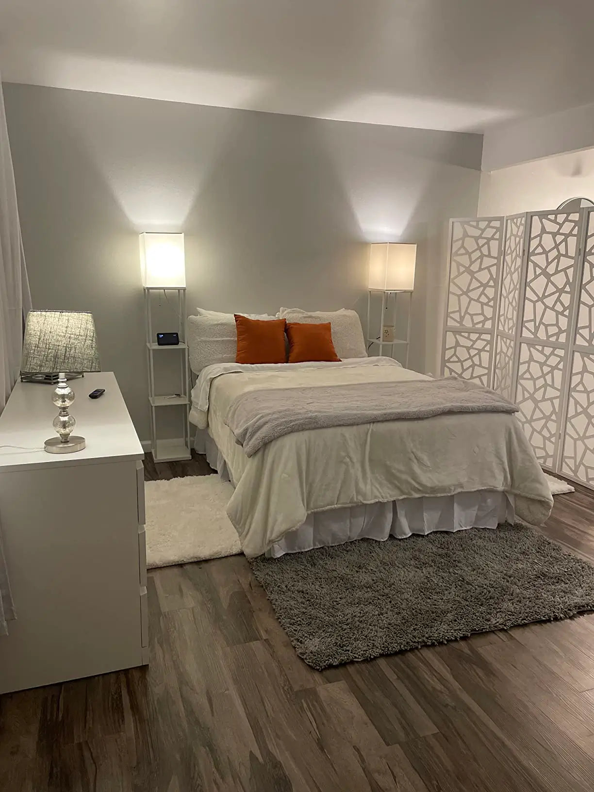 An elegant floor lamp with a tall, slender stand adorned with lampshade, adding a touch of luxury and sophisticated lighting to a refined interior space