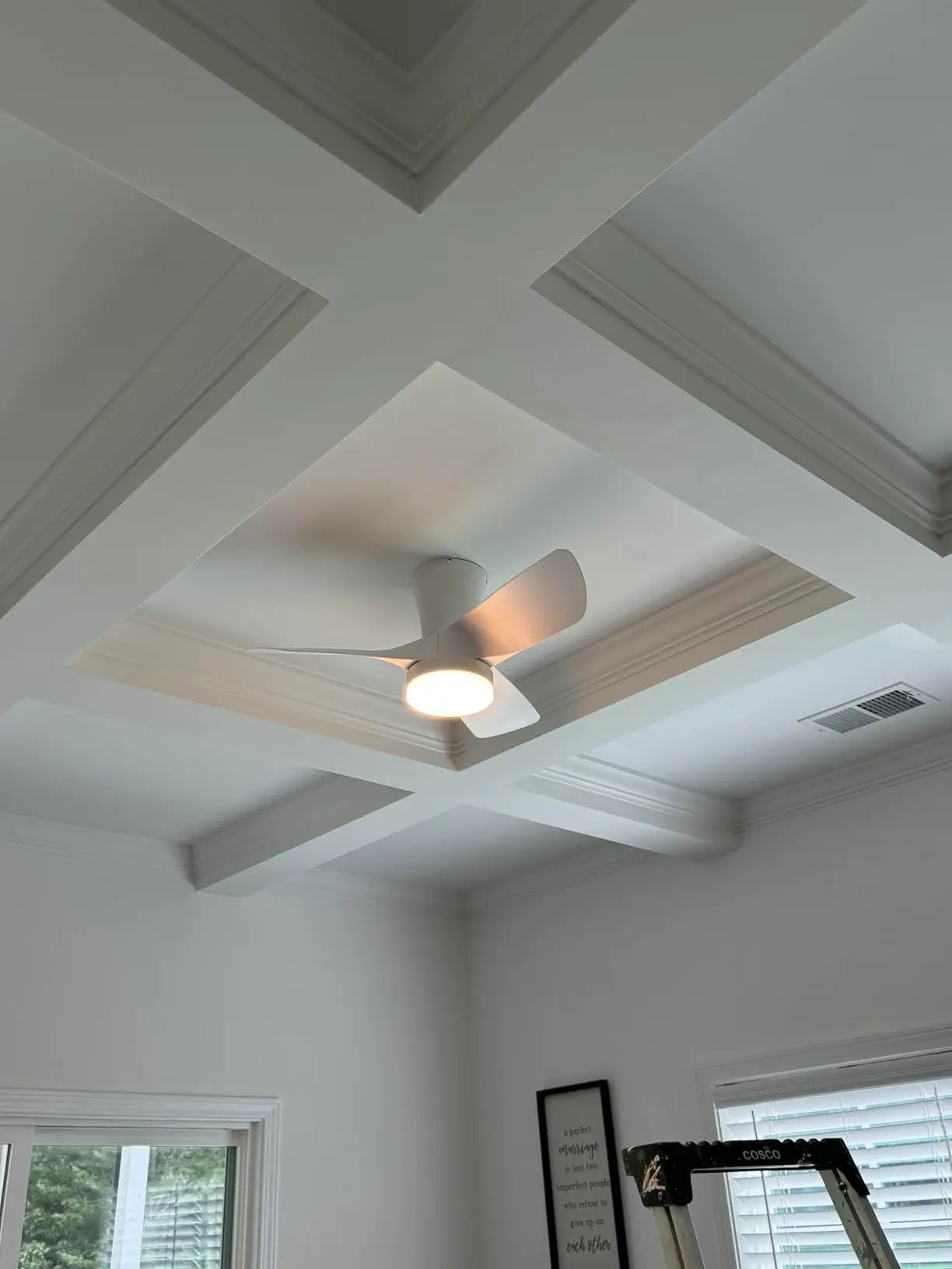 A low-profile, flush-mount ceiling fan with a built-in light, perfect for rooms with lower ceilings, offering unobtrusive air movement and illumination.