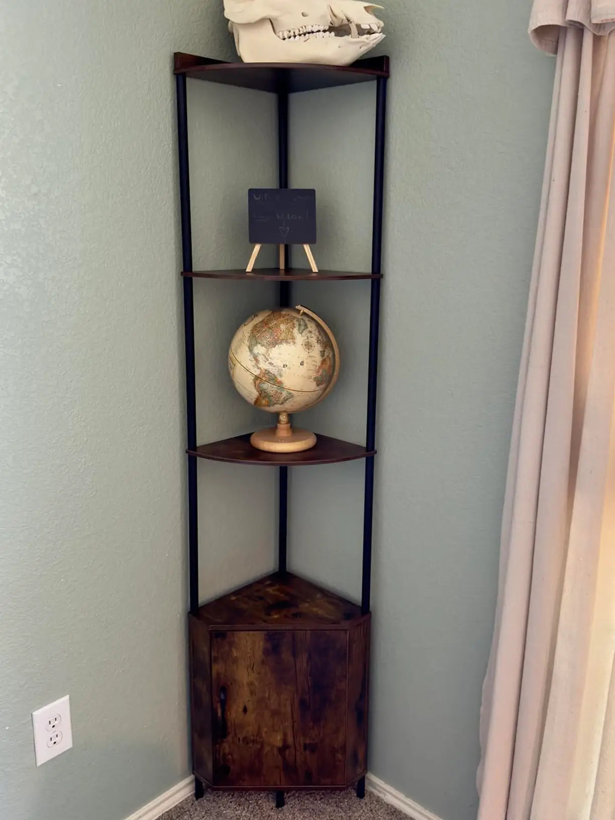 An industrial-style corner cabinet shelf combining dark metal frames with wooden shelves, providing a sturdy and stylish storage unit for a modern or urban interior.