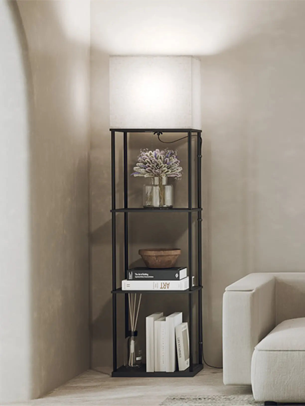A minimalist floor lamp featuring a stand light, upward-facing square shade, casting soft ambient light in a cozy bedroom setting.