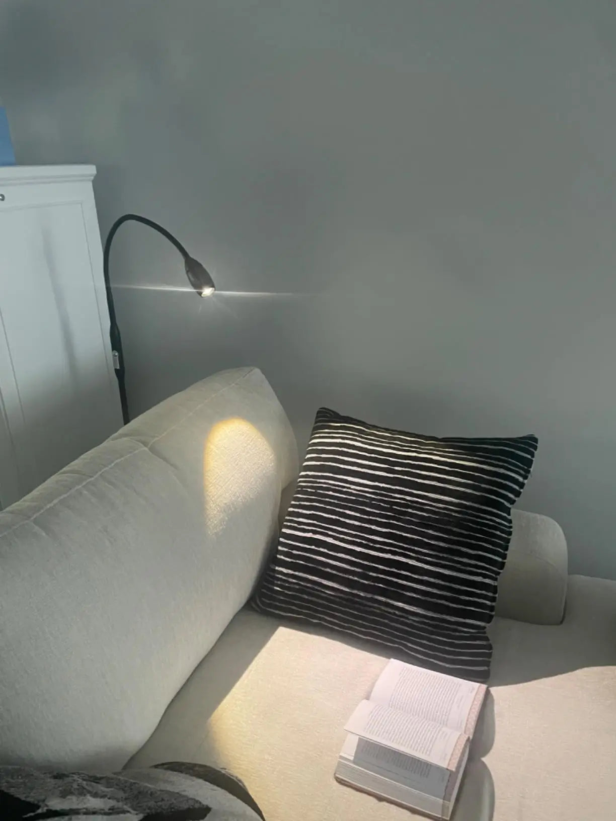 A sleek silver LED spotlight floor lamp with a minimalist design, offering a bright and narrow beam of light perfect for highlighting architectural features or artwork in a gallery.